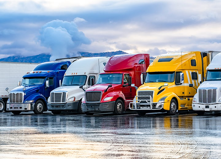 semi trucks parked in warehouse parking lot