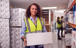 A woman working inside a busy warehouse