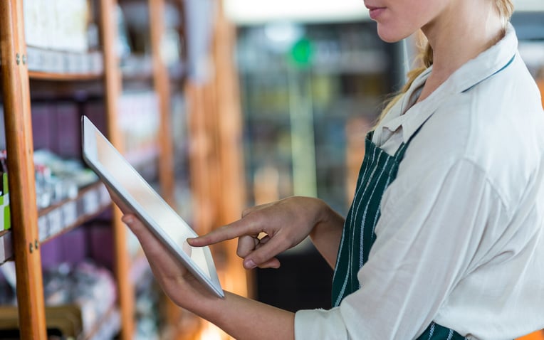 Female staff member using tablet for the best 3PL for ecommerce blog