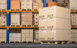 Photo of warehouse with cardboard boxes on pallet for challenges in order fulfillment process blog