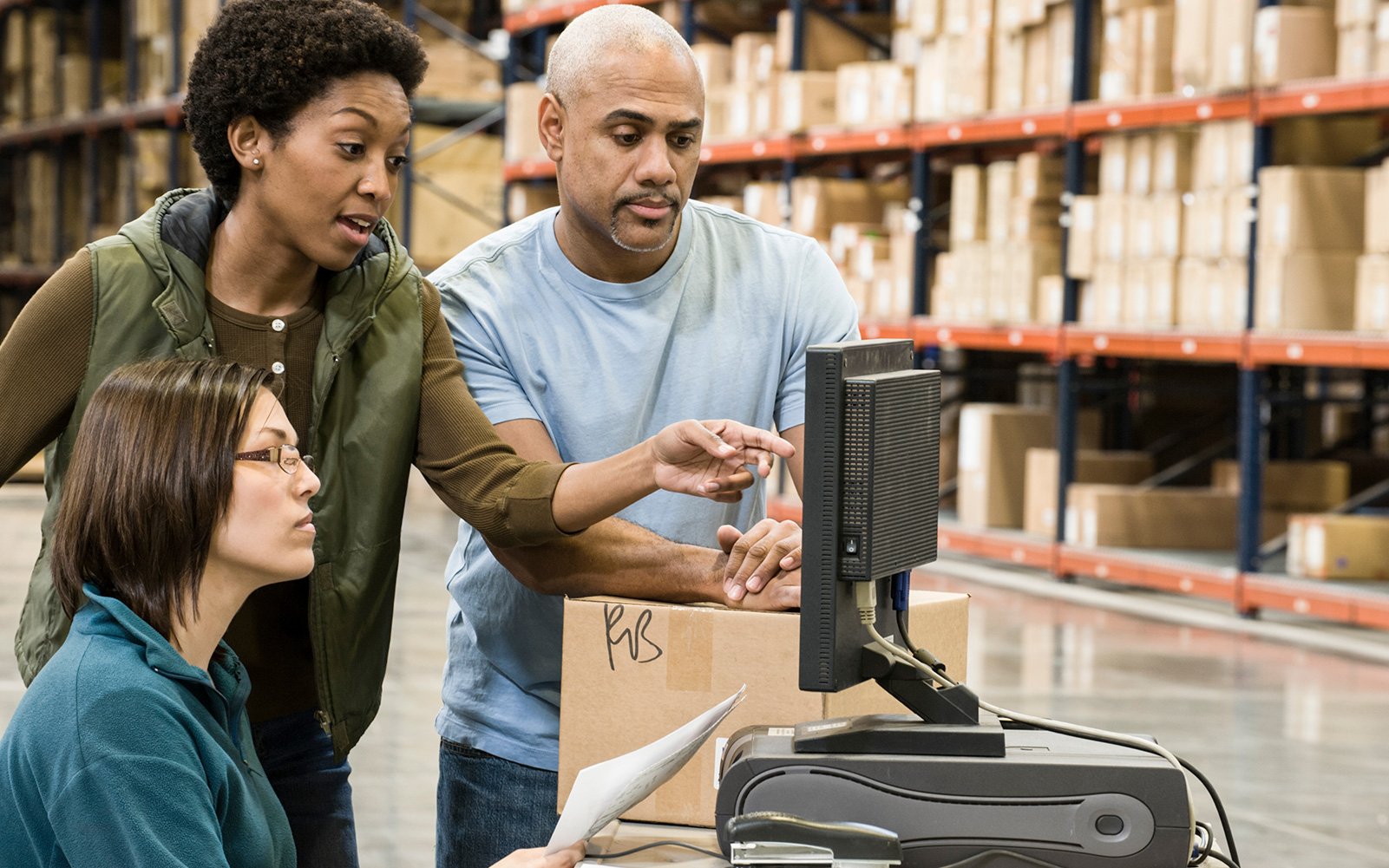 Warehouse-workers-consult-their-short-term-demand-forecasting-software-to-evaluate-stock-levels