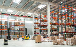 Warehouse worker managing logistics in a large distribution center for the best 3PL fulfillment services of 2025 blog
