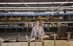 Woman in a large distribution warehouse for the 3PL fulfillment pricing guide