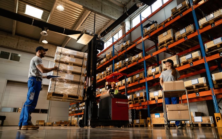 Below view of a group of workers cooperating in a warehouse for the dedicated warehousing solution optimization page.