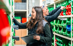 A warehouse worker uses optimized inventory management strategies to quickly and accurately pick and order