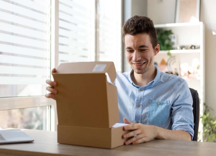 man unboxing personalized ecommerce order