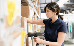 Warehouse worker picks a customer’s order off one of the storage racks