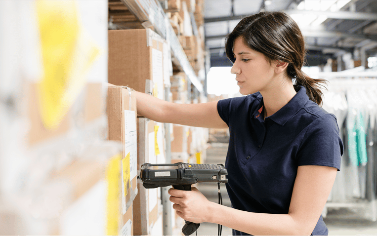 Warehouse worker picks a customer’s order off one of the storage racks