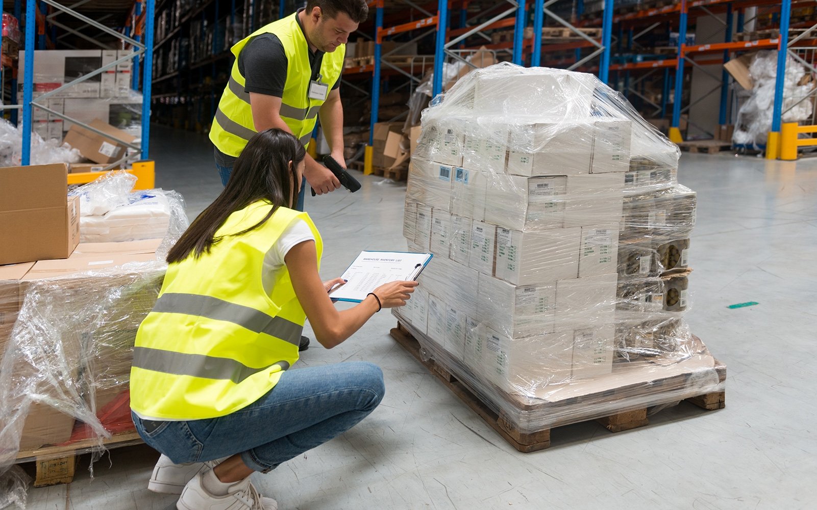 Warehouse-worker-checks-expiration-on-a-pallet