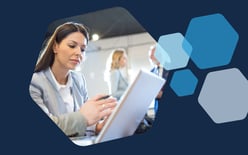 woman on laptop with people talking in background