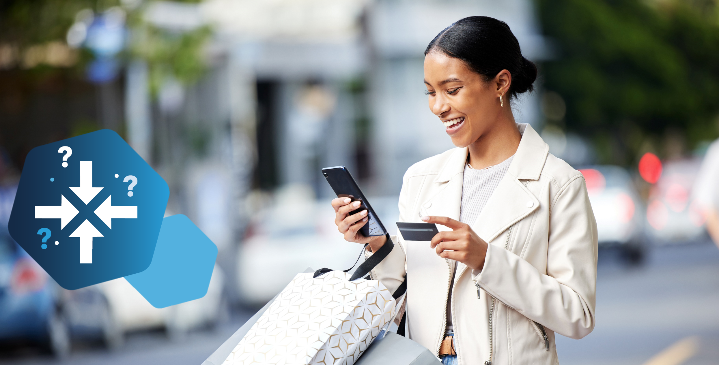 woman holding credit card and scrolling on mobile phone, carrying shopping bags