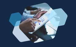 person scrolling on tablet with graphs