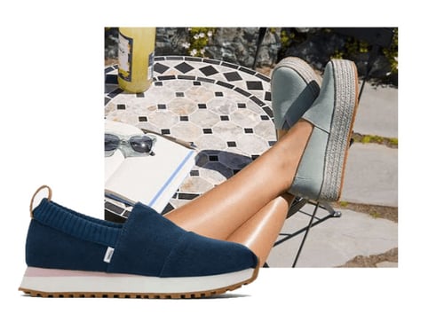 blue toms shoe, woman wearing pair of toms brand shoes