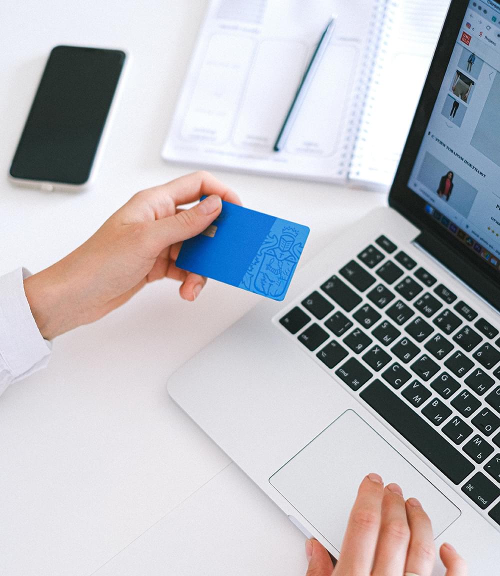 Woman holding a credit card and shopping online